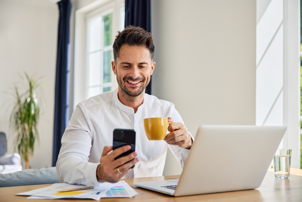 Happy man looking at phone