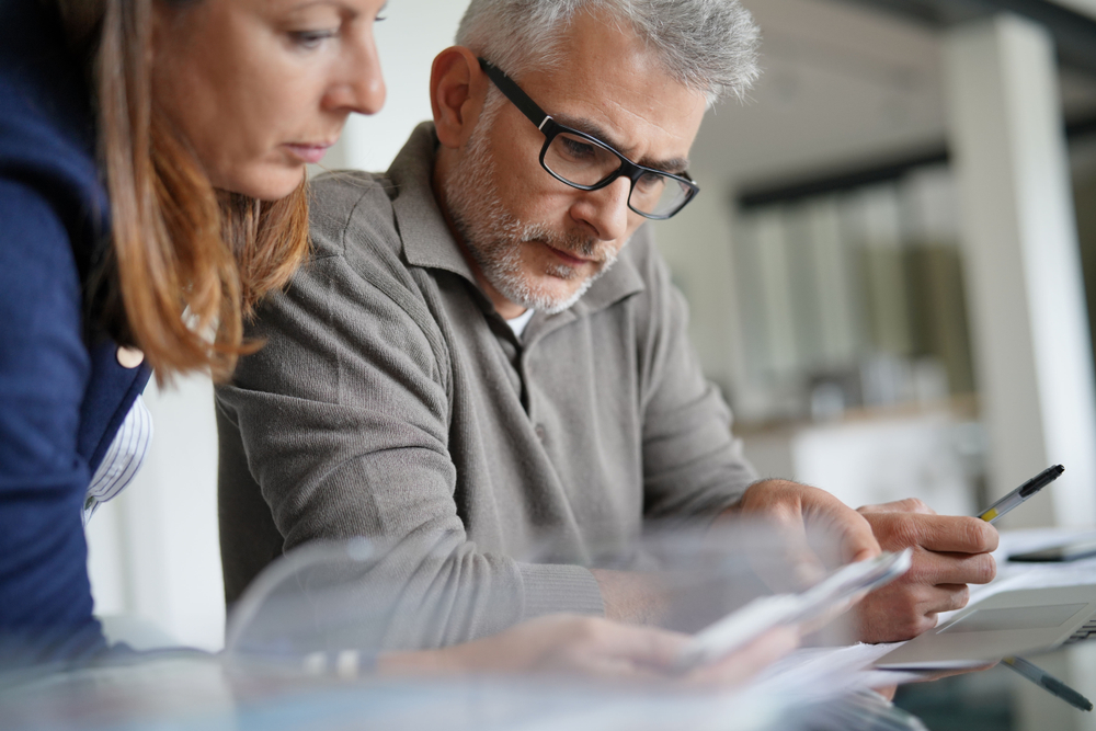 Two people looking at documents